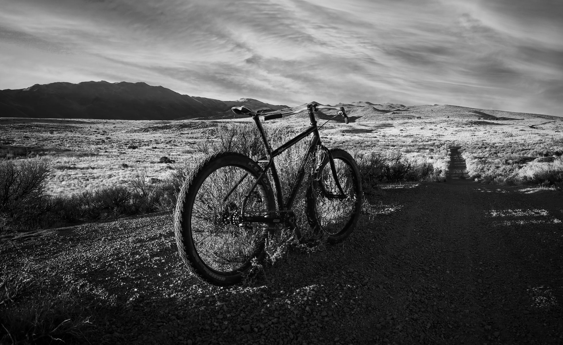 A single-speed converted mountain bike on a desert dirt trail near Reno, Nevada, under a wide sky.